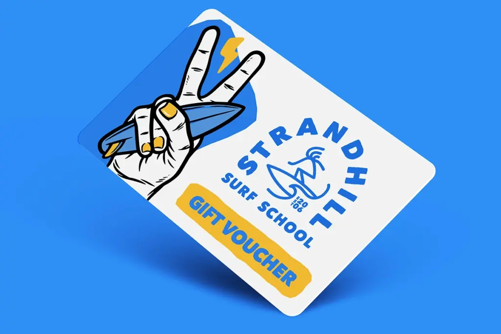 A Gift Vouchers Strandhill Surf School card featuring a hand making a peace sign whilst holding a surfboard, with "GIFT VOUCHER" in yellow on a blue and white background.